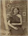 Sallie, a Hopi woman, standing in front of a blanket