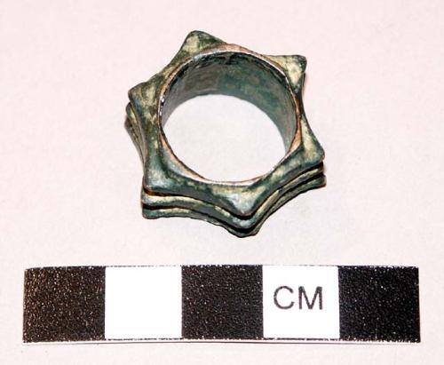 Hexagonal segmented ring of patinated bronze--a single ring consisting of 3 dist