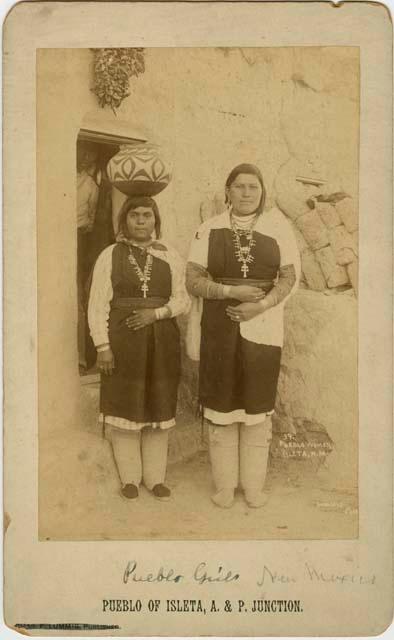 Two women standing outside doorway