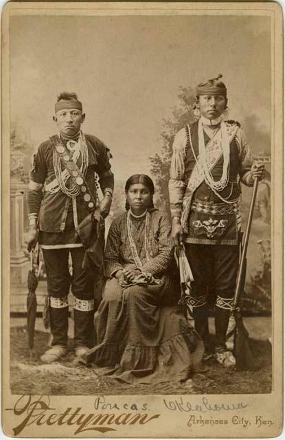 Studio photograph of two men and a woman