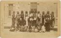 Group of men in front of a brick building