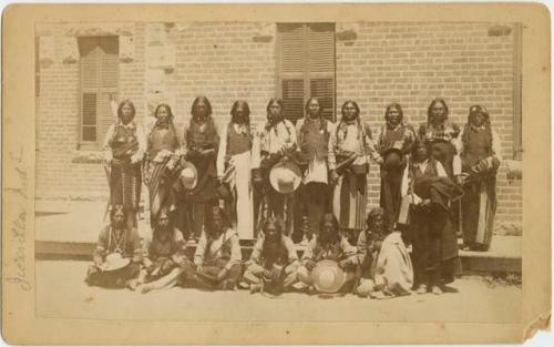 Group of men in front of a brick building