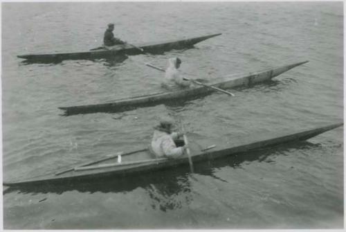 Three men in kayaks