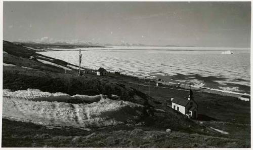 Catholic church and other buildings along shore