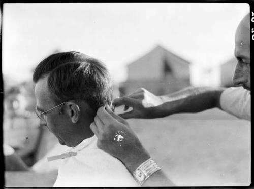 Peter Blos cutting Watson Smith's hair.