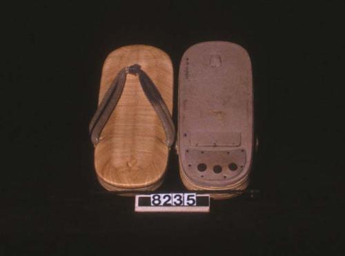 Pair of shoes made of rice straw with gold, silver and blue straps as foothold