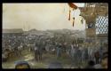 Lantern slide of crowd, animals and carts, hand-colored