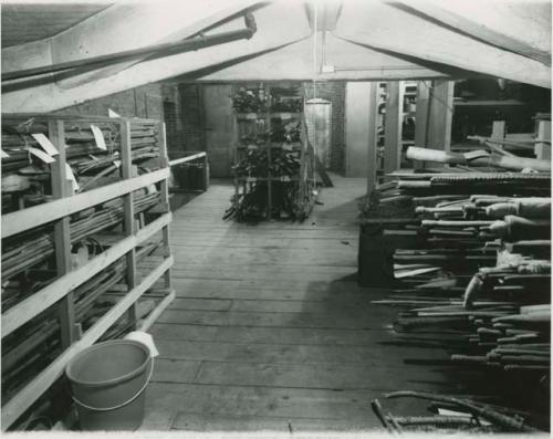 Historical photograph of Peabody Museum attic storage shelving with  wooden objects