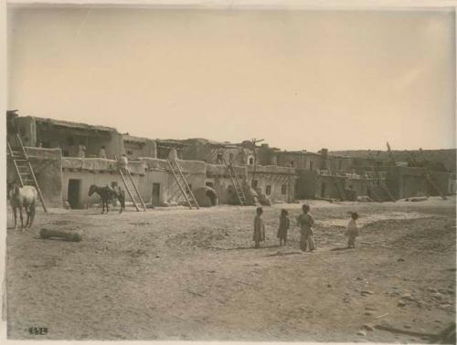 View of  village with children and horses