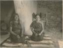 Two Hopi women, one with squash-blossom hairstyle done by the other woman