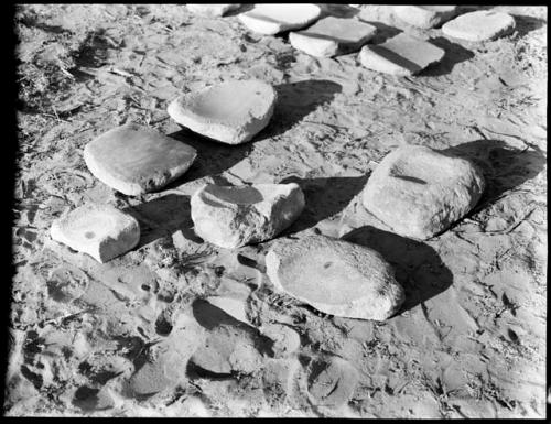 Group of 6 metates, 211 behind them