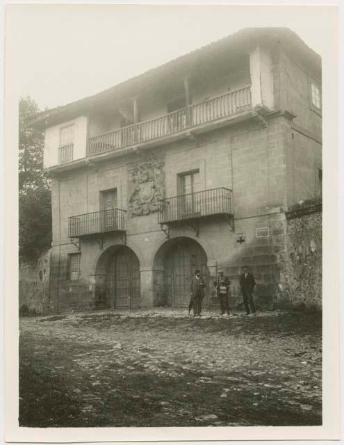 Three men standing in front of building,Santillana, Spain