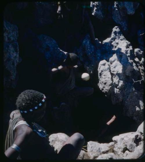 Waterhole: Men climbing into waterhole to get water