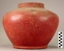 Ceramic jar, red slip, round body, tapered annular base, straight neck and rim