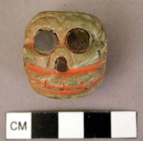 Small carved skull of gray-green stone-traces of vermillion coloring