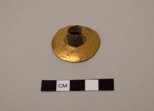 Gold object - ear plug