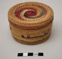 Small covered basket with purple and red designs