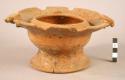 Pottery bowl with flaring base & jsecondary rim.  The latter is in form of 2 bir