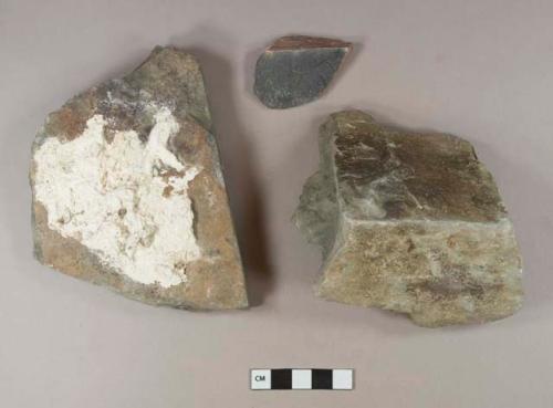 Non-cultural stone fragments. One is burned, one has mortar on it