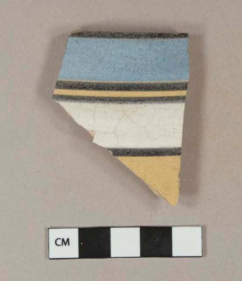 Blue, white, black and yellow slip decorated annularware, vessel body fragment, buff paste