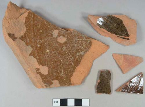 Brown lead glazed interior redware vessel body and base fragments