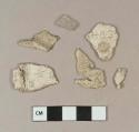 Aqua flat glass fragment; white styrofoam sheet fragments, one stamped with "H83" and one stamped with "HANOI"