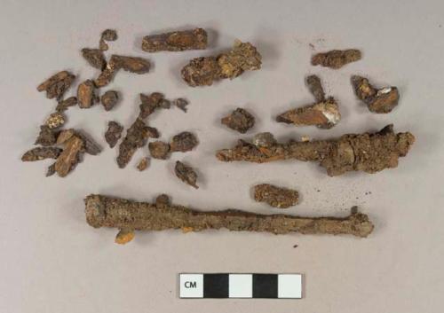 Iron nail fragments, some cut or wrought; iron nail fragments with charcoal attached; iron nail fragments with coal fragments attached; iron nail fragments with mortar fragments attached; iron nail fragments with wood fragments attached; charcoal fragment; wood fragment; unidentified iron fragments