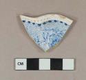 Blue transfer printed whiteware rim sherd with molded dots along rim