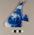 Flow blue whiteware plate sherd; maker's mark stamped: "STONE J & G ALCOCK" and "7", printed: "SCINDE". Scinde is the name of the pattern.