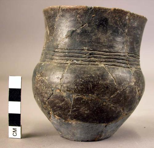 Ceramic jar, black burnished, incised, heavily mended and reconstructed, + 3 she