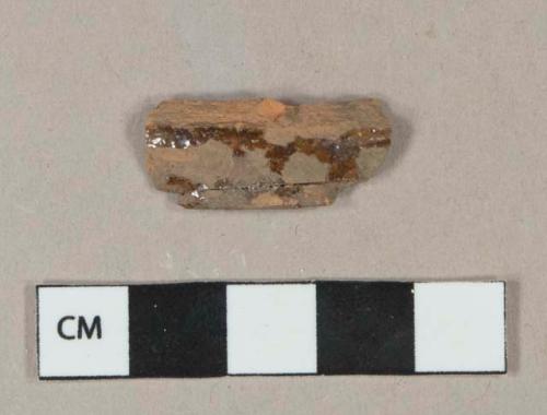 Dark brownish red lead glazed redware vessel body fragment