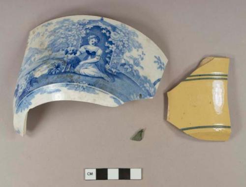 Blue transfer printed whiteware bowl sherd; yellow ware rim sherd with blue filled incised line decoration; aqua bottle glass fragment