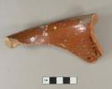 Redware rim sherd with undecorated brown glazed interior and undecorated unglazed exterior