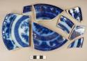 Flow blue whiteware plate sherd with makers mark: "Temple / Pearl Stone"; flow blue whiteware bowl sherd; flow blue whiteware base sherd; five flow blue whiteware rim sherds, two of which were previously glued together