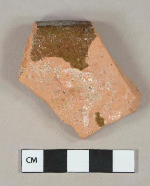 Brown slip-glazed redware vessel rim fragment, unglazed exterior