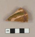 Slip decorated lead glazed redware base sherd