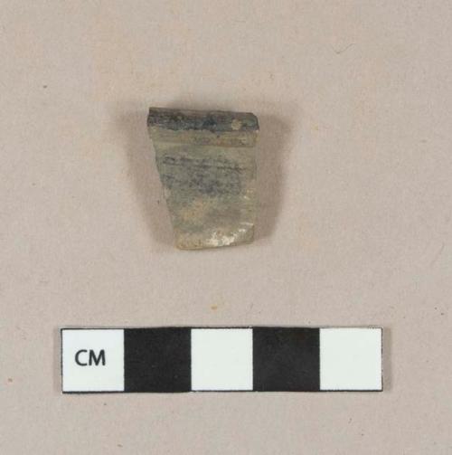 Burned, undecorated lead glazed redware rim sherd