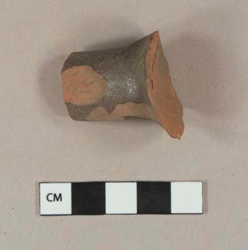 Undecorated lead glazed redware handle sherd