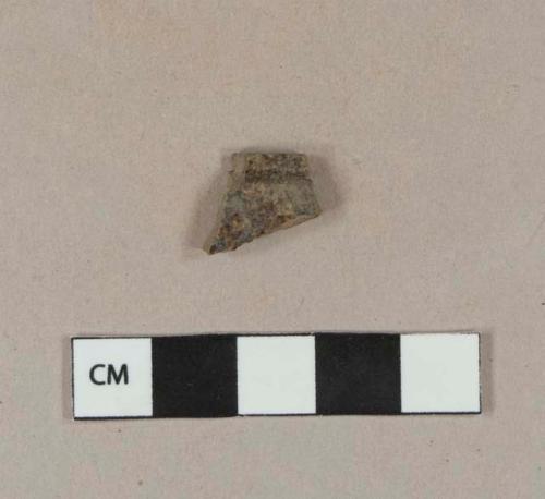 Possibly burned, undecorated lead glazed redware rim sherd