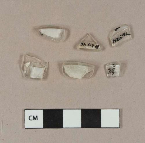 Colorless glass fragments with rolled rims, possible stemware base fragments