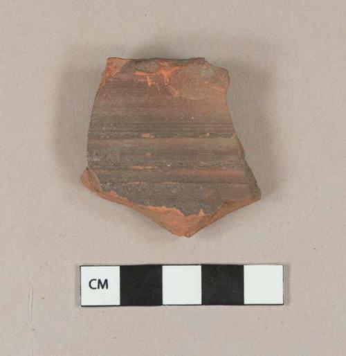 Molded, unglazed redware rim sherd