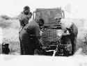 Expedition members working on the Jeep