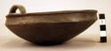 Profilated pottery bowl, over-looped handle