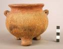 Large tripod pottery jar with two perforated lugs and short legs - scarified