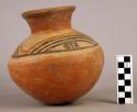 Pottery jar, red base with black and red ornament on upper yellow zone