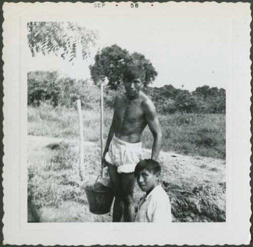 Photograph album, Yaruro fieldwork, p. 11, photo 1, man with bucket