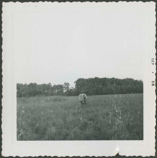 Photograph album, Yaruro fieldwork, p. 17, photo 3, Venezuela landscape with two Yaruro people