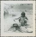 Photograph album, Yaruro fieldwork, p. 23, photo 6, woman pouring food in pot