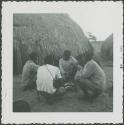 Photograph album, Yaruro fieldwork, p. 24, photo 1, people eating in a circle