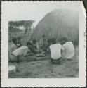 Photograph album, Yaruro fieldwork, p. 24, photo 2, people eating in a circle